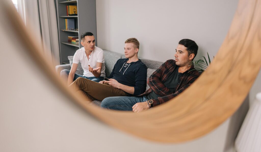 Men connecting and supporting each other in a sober living home